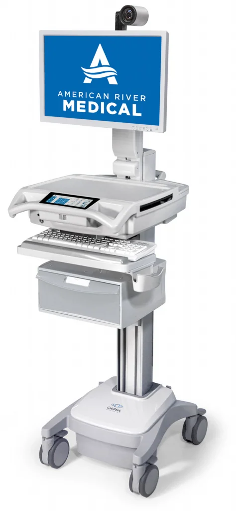 Mobile medical cart with monitor displaying American River Medical logo, mounted camera, keyboard tray, and storage drawer on wheeled base