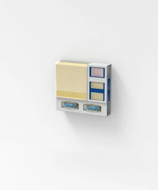 Wall-mounted organizer with yellow sticky note pad, blue compartments with fabric samples, and two blue containers below